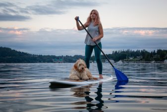 Girl with dog on a paddle board Girl with a dog on a paddle board during a vibrant summer sunset. Taken in Deep Cove, North Vancouver, BC, Canada.